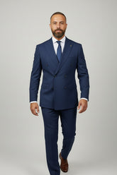 Man wearing a navy double-breasted suit with tailored fit and elegant design.